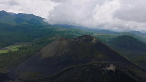 Drone Circles Stunning Parícutin Volcano with cloudy Mountains in Background Stock Footage 314875243