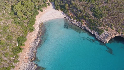 Drone circling around empty beach with blue water Stock Footage 100264476