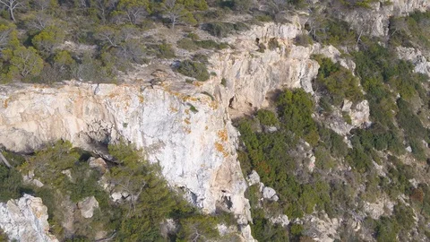 Drone circling around large cavern in cliff Stock Footage 100264588