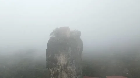 Drone is circling around the massive limestone column in the fog, Georgia, 4k Stock Footage 168472680