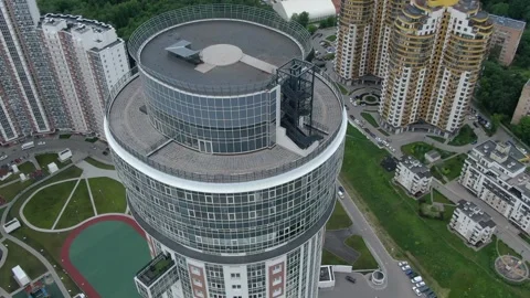 Drone circling around modern round skyscraper complex Stock Footage 333484664