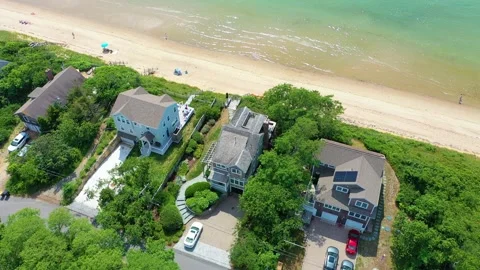 Drone Circling Cape Cod House Near Shoreline Vídeos de archivo 317696731