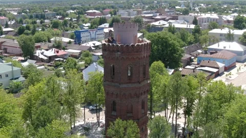 Drone circling historic brick tower in town Video stock 333484617