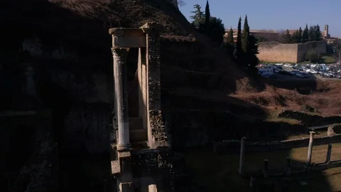 Drone circling old ruins of ancient Roman Theatre in Italy Stockbeeldmateriaal 117799065