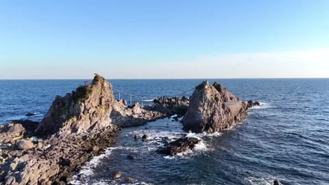 Drone Circling View of Sacred Three Stones in Ocean Kanagawa Japan 4K Stock Footage 329058632