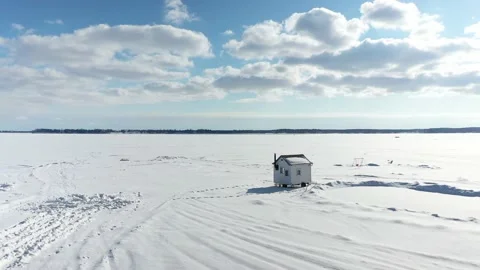 Drone circular flight around the ice fishing cabin on Lake of Two Mountains, Stock Footage 164382470