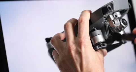 The drone is cleaned with a brush and the camera is rubbed by the hands of a man Stock Footage 155922798