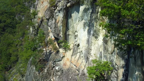 Drone cliff mountain rock forest aerial ascending Stock Footage 346085770