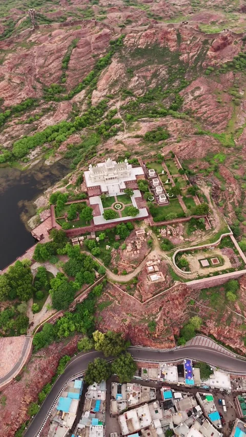Drone clip capturing quiet beauty of temple beside majestic Mehrangarh Fort Stock Footage 310660319