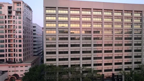 Drone clip rising above Rooftops in the City Stock Footage 250500536