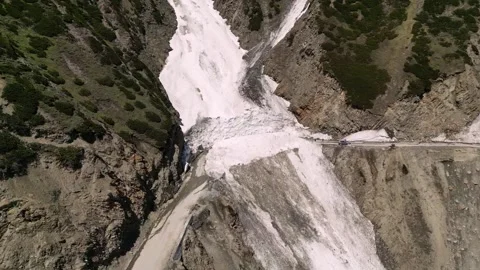 Drone clip of the serpentine highway slashed through Zojila’s cliffs. Stock Footage 310806693