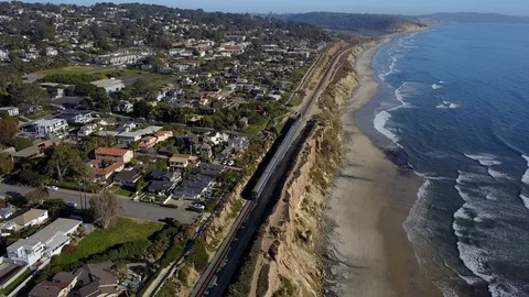 Drone clip of train on a cliff over the ocean in San Diego Stock Footage 87954414
