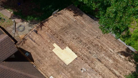 Drone close up aerial view of the residential roof replacement in progress Stock Footage 341784887