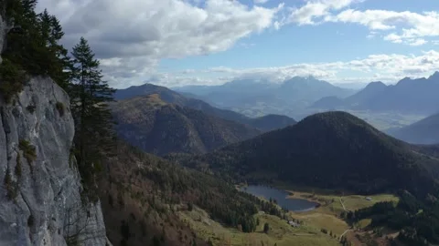 Drone close to cliff revealing epic mountain scenery with lake (Austrian Alps) Stock Footage 152305147