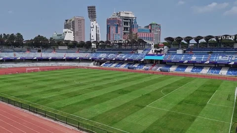 Drone close-up of the empty M. Chinnaswamy Stadium in front of UB City buil.. Video stock 330274604