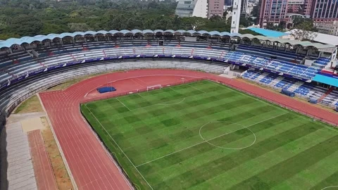 Drone close-up of the empty M. Chinnaswamy Stadium in front of UB City buil.. Stock-Footage 330274609