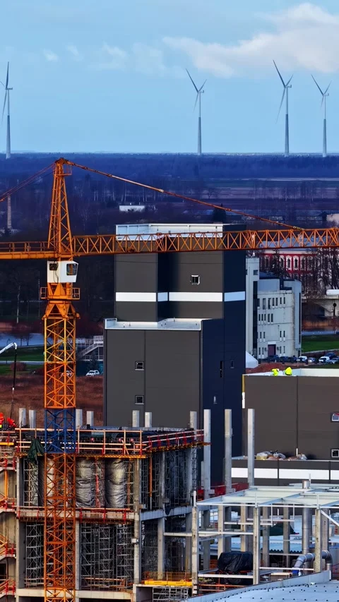Drone Close-Up of Industrial Construction Site with Wind Turbines in Snowy Stock Footage 337150119