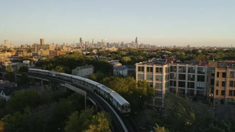 Drone Closely Follows Chicago El Subway Train Entering Neighborhood during Stock Footage