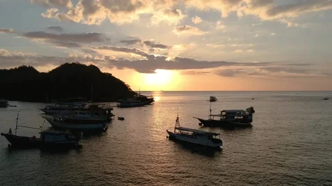 Drone, cloudy sunset and boat silhouettes over ocean, Indonesia Video stock 131434423