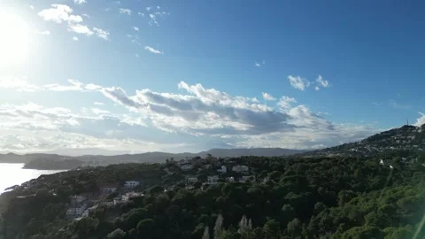 Drone cloudy sunset sea view, coastline with mountain and houses,4K Stock Footage 274843590