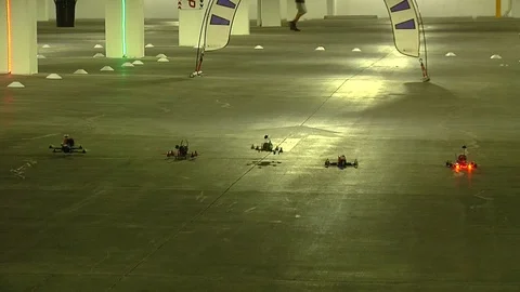 Drone competition taking place in a parking lot Stock Footage 99050674