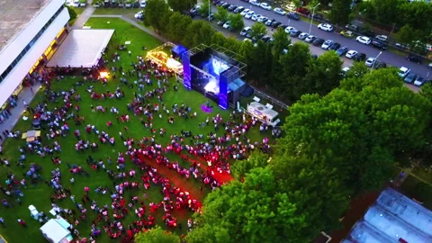 Drone concert stage with crowd circular flight 100 mts 45 degree afternoon Stock Footage 247943152