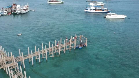 Drone, construction workers building a wooden jetty, Indonesia Stock Footage 131434449