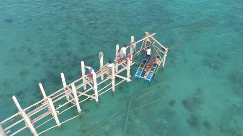 Drone, constructions workers building a wooden jetty on the water, Indonesia Stock Footage 131434529