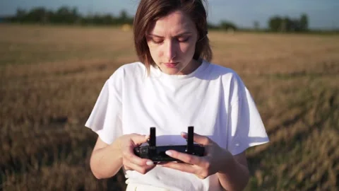 Drone control. Female pilot tries to control quadcopter in flight Stock Footage 137703438
