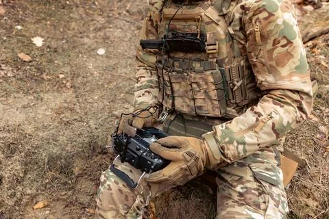 Drone control panel is in hand of military soldier. Artillery spotter or mili Stock Photos