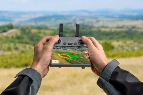 Drone controller displaying NDVI crop analysis for precision farming, showi.. Stock Photos