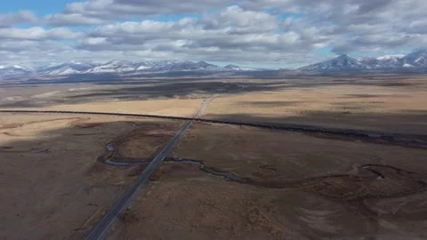 Drone of Country Road Intersecting Train in North Nevada Stock Footage 197924422