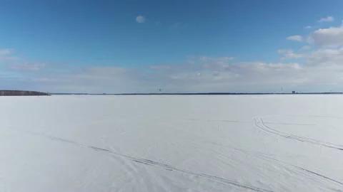 Drone crane shot coming down over the frozen Lake of Two Mountains in Oka Stock-Footage 164381581