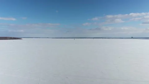 Drone crane shot flying higher and higher revealing the numerous kitesufer Stock Footage 164382601