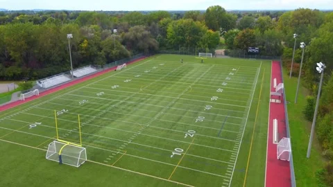 Drone crane shot going up and panning down over the football field in Laval.. Stock Footage 256063006