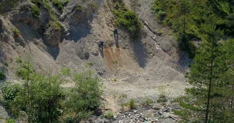 Drone Crane Shot Two Men Climbing To Top Of Slope Stock Footage 112237414