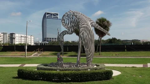 DRONE CRANES ROOST PARK FORWARD DOLLY ZOOM OF THE NURTURE ART SCULPTURE Stock Footage 244539336