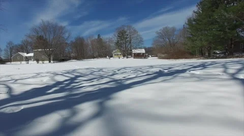 Drone crashes into tree top and releases snow from the tree 库存影片 62860866