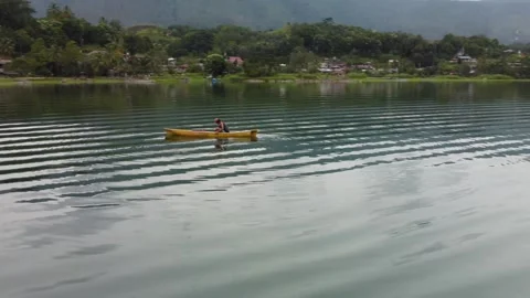 Drone Curve Left to Right Over Fisherman in Canoe, Lake Toba, Indonesia Stock Footage 315248048