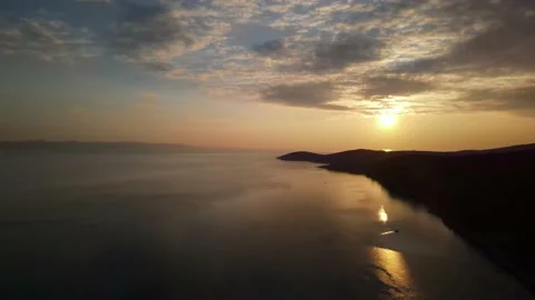 Drone decending to coast at sunset Stock Footage