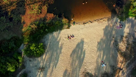 Drone declines and rotates over  relaxing family a sandy beach old river on a Stock Footage 148631054