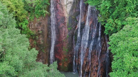 Drone decsends on tropical waterfall from up to down Stock Footage 331622543