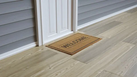Drone delivering ordered package to the door, leaving it on a doormat. 4KHD Stock Footage 119988124