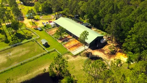 A drone delivers a dramatic perspective up high of a horse ranch near the Stock Footage 155429859