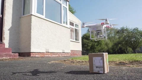 Drone Delivers Parcel Package to a Resident Home, Future Door Delivery by UAV Stock Footage 75461478