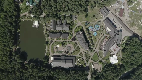 Drone descending above hotel complex and lake Stock Footage 329833667