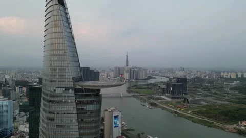 Drone Descending Alongside a Modern Skyscraper in Ho Chi Minh City, Vietnam Stock Footage 335601847