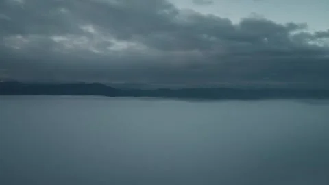 Drone descending into clouds at sunrise Stock Footage 323619301