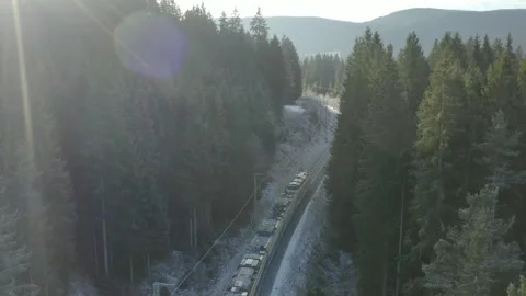 Drone descending over electric train with sparks on winter forest railway Video stock 328005841