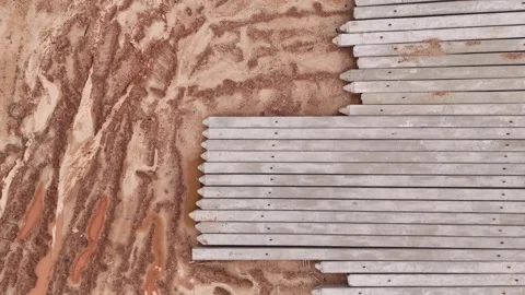 Drone Descending Over Foundation Piles and Orange Soil Vídeos de archivo 337623250